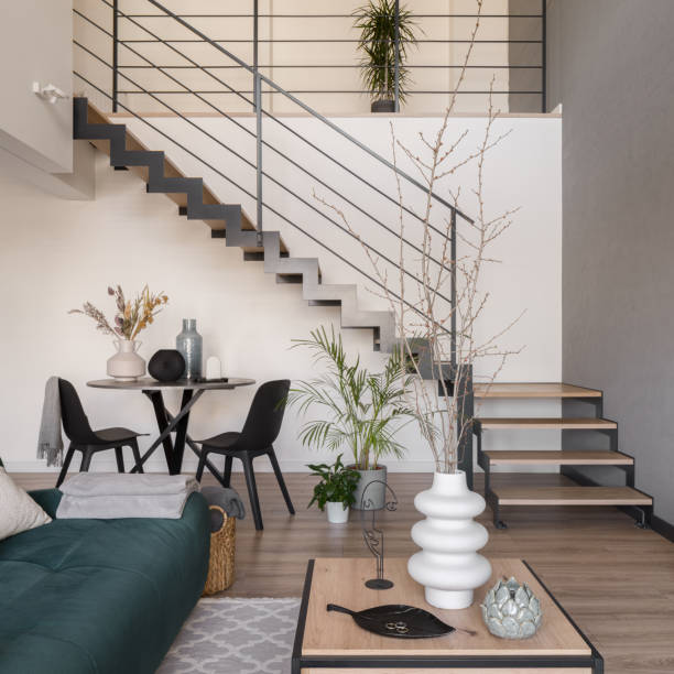 Modern staircase in living room with table stock photo