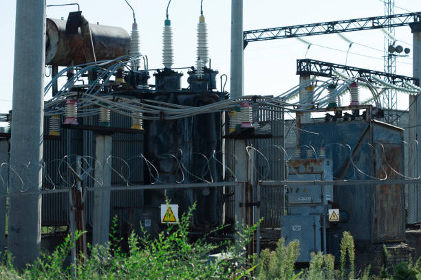 old damaged high voltage transformer substation. rust on structures stock photo
