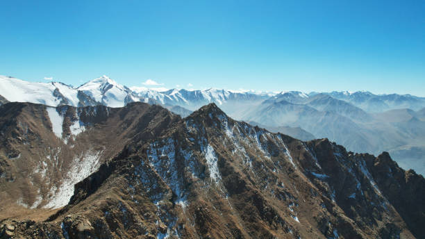 istock Snowy rocky mountain peaks in a light haze. 1432408227