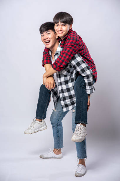 istock Two loving men wore striped shirts and rode their backs. 1432409864