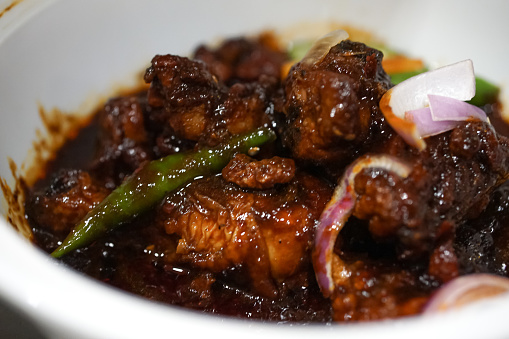 A bowl of chicken cooked in sweet soya sauce, called Ayam Masak Kicap