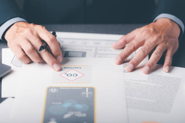 istock Industrial emissions pollute the environment and ecosystems. Including climate change, renewable energy agreements, carbon emissions reductions, business people check documents on tables. 1432410366