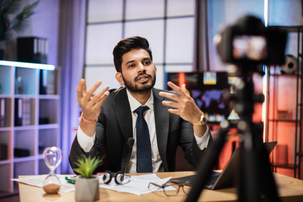 istock Attractive confident experienced smart indian bearded office manager recording video vlog 1432410730