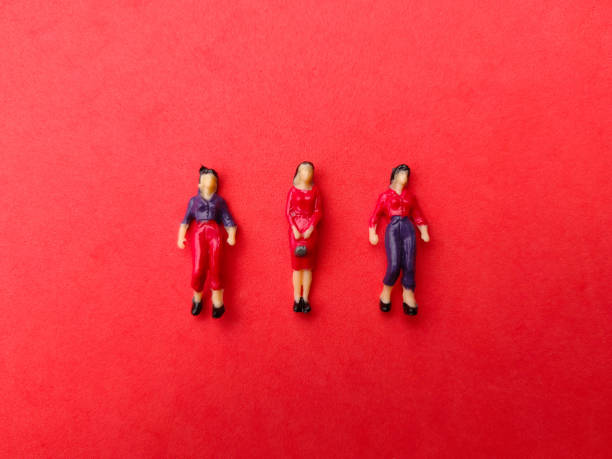 istock Miniature people are neatly arranged on a red background. 1432410839