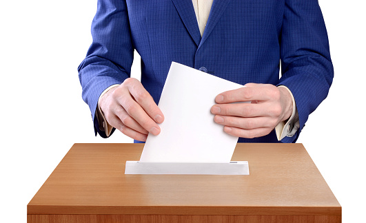 Man votes by throwing a ballot into the ballot box. Referendum of the state, country. Election Day. Isolated on a white background.