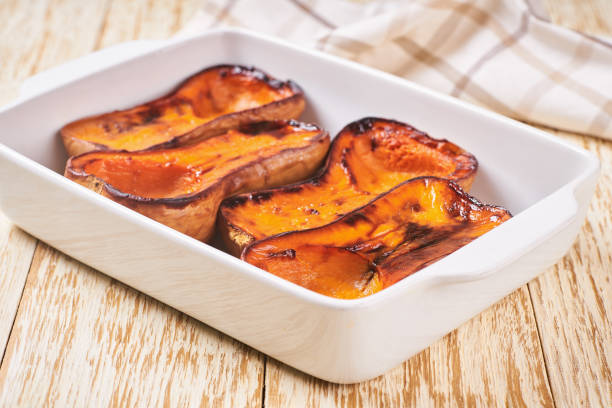 istock baked butternut squash halves in a ceramic bowl. 1432411356