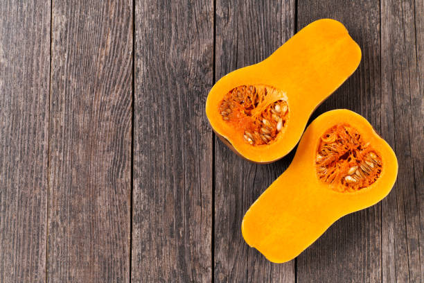 istock Butternut squash cut in half on a wooden table copy space for text. 1432411364