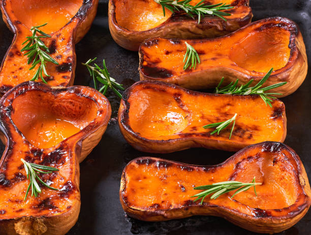 istock Close up of roasted butternut squash half with rosemary. 1432411370