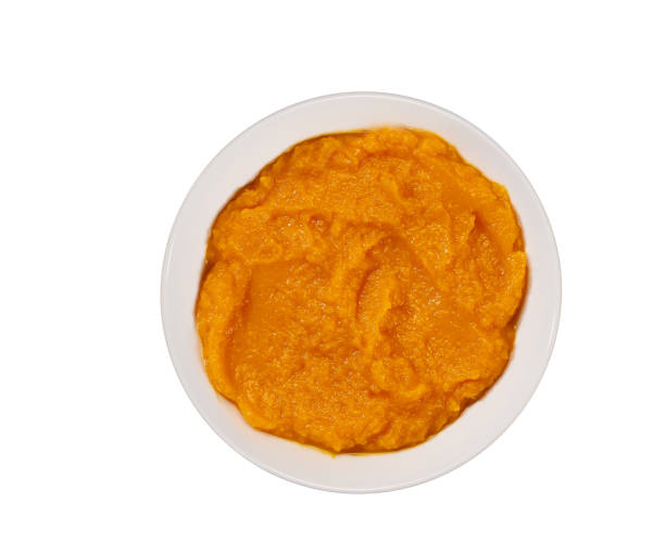 istock Pumpkin puree (mashed butternut squash) in white ceramic bowl isolated on a white background. 1432411394