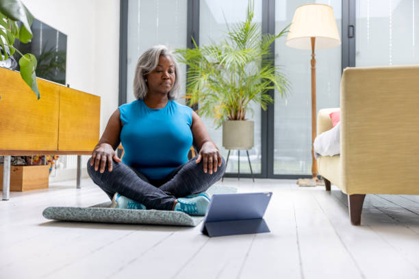 istock Senior woman taking a yoga class online 1432413300