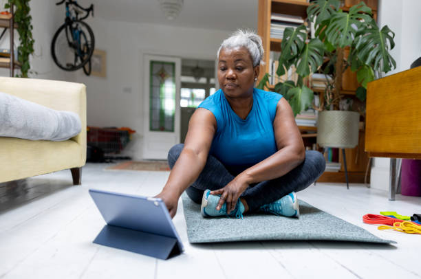 istock Senior woman doing her home workout following an online class 1432413314