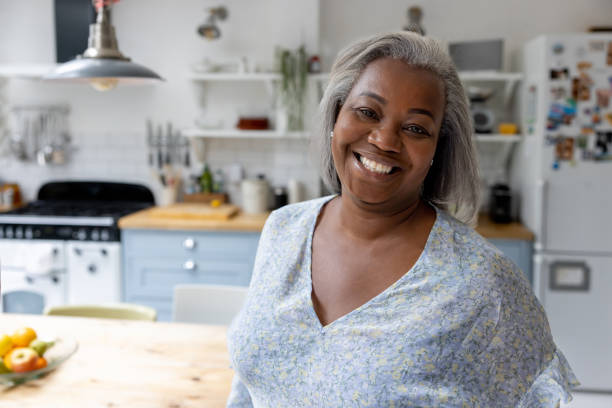 istock Happy woman at home smiling in the kitchen 1432413379