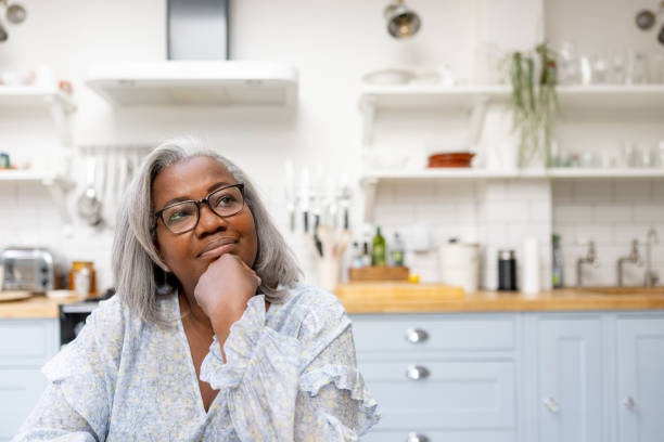 istock Mature woman at home looking thoughtful 1432413415