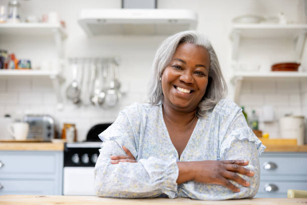 Happy woman at home smiling in the kitchen