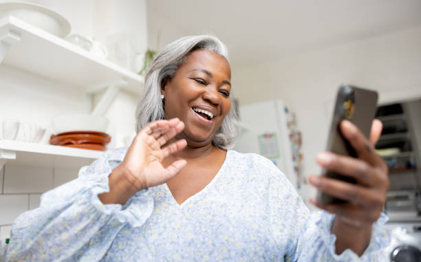 istock Senior woman at home greeting on a video call 1432413429
