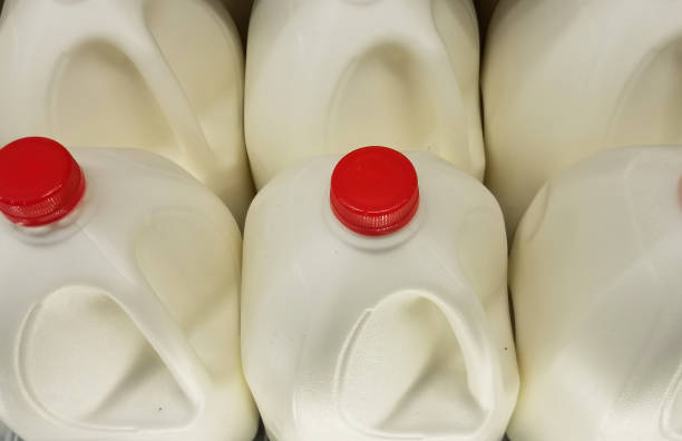 Gallons Of Milk Close Up High angle close up of milk bottle gallons. gallon stock pictures, royalty-free photos & images