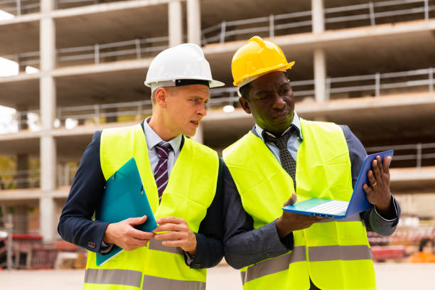 istock Two civil engineers contols the progress of work on a laptop 1432416955