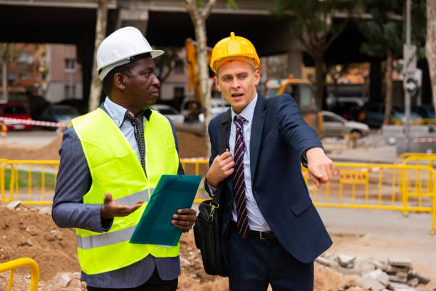 istock Architect tells engineer where to dig a trench to lay pipe 1432416956