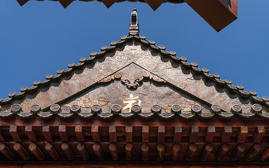 Chinese style traditional roof and red wall detail