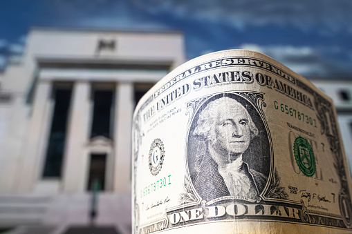 dollar on the background Federal Reserve Building in Washington DC, United States, FED