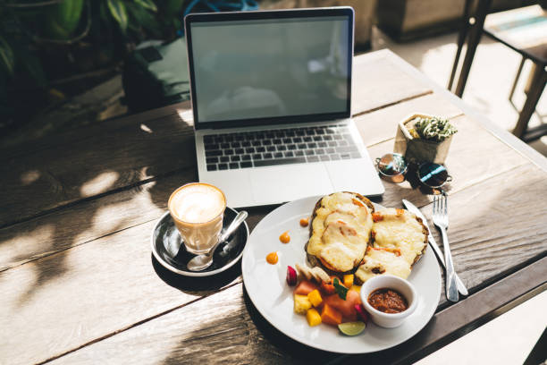 istock Laptop and breakfast on table in cafeteria 1432421525