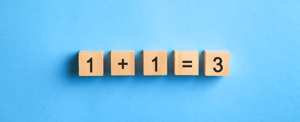 istock 1+1=3 on wooden cubes. Synergy 1432421544