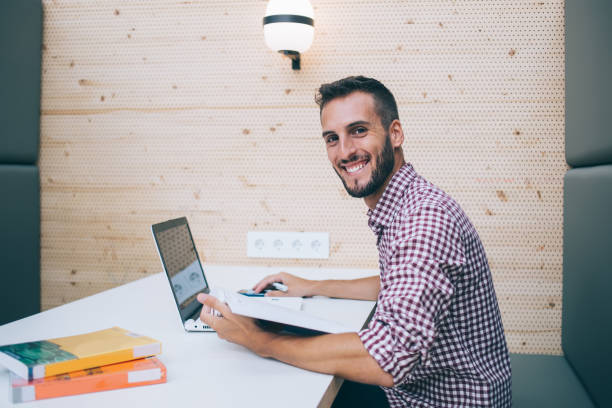 istock Excited male reviewing report using laptop at work space 1432422291