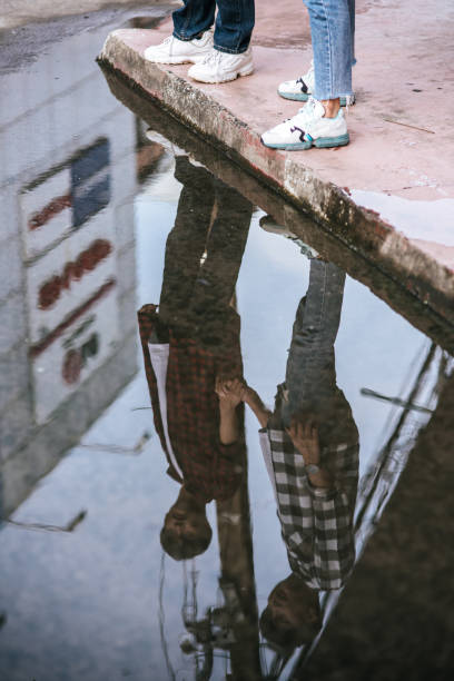istock Two beloved young men in shirts and standing on the curb. 1432424937