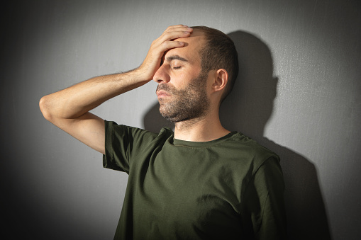 Caucasian stressed man at home.