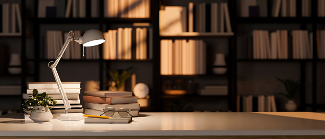Close-up image, Empty copy space on working tabletop with books, eyeglasses, decor plant and table lamp over blurred bookshelves in the background. 3d render, 3d illustration