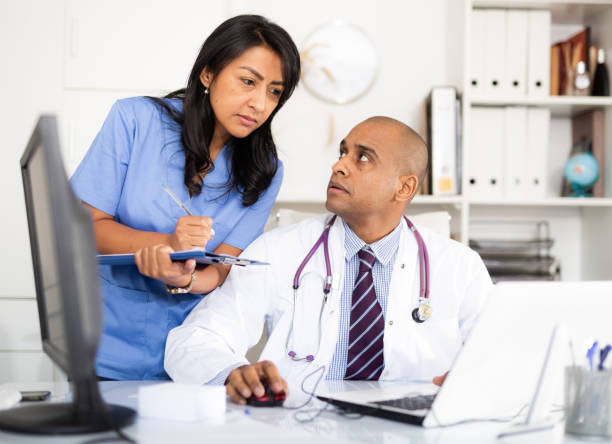 istock Doctor and nurse check patient data in hospital computer 1432426781