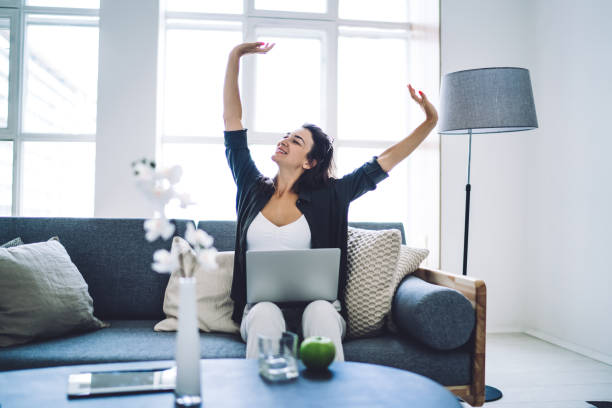 istock Cheerful woman resting after working on laptop 1432428194
