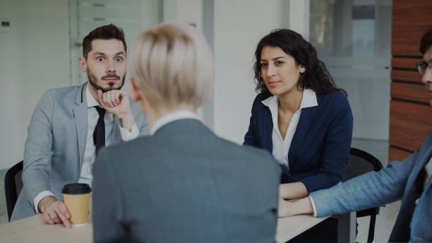 istock Business team chatting while sitting in modern office indoors during coffee break 1432428522