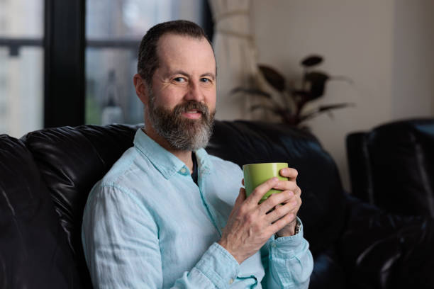 istock Smiling man enjoying a coffee indoors 1432429226