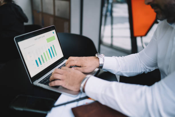 istock Cropped image of male professional working remotely with web statistics analyzing informative graph chart, skilled financial expert checking digital marketing report during distance job via netbook 1432429288