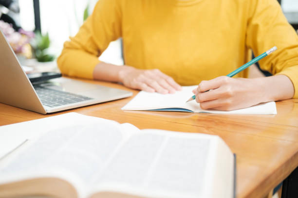 istock Close up of woman studying online using laptop. 1432430667