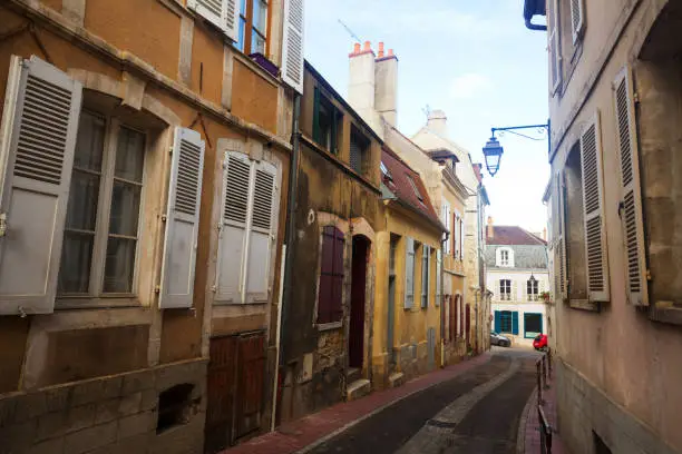 View of old narrow streets of French city of Auxerre in autumn day