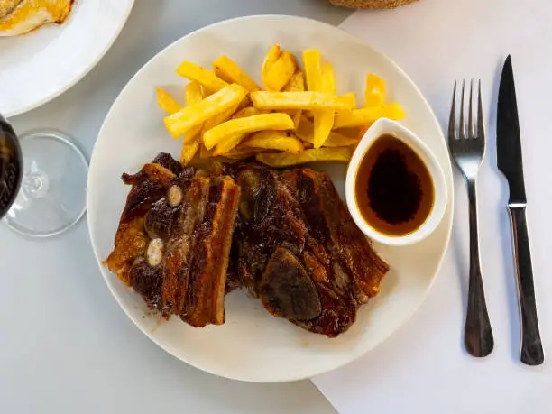 Photo of Grilled beef ribs with french fries and sauce