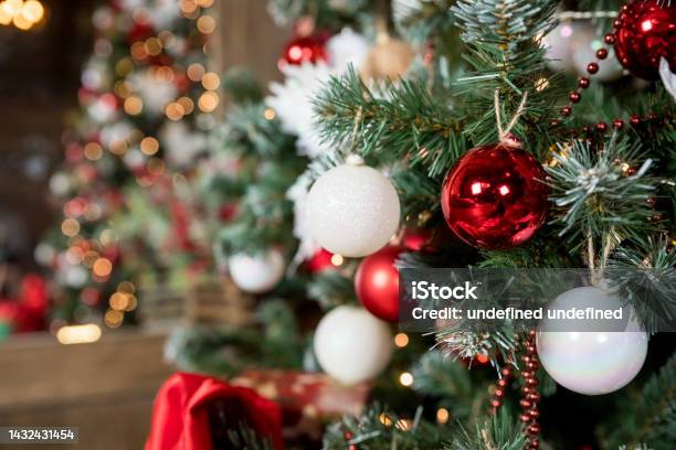 Magic Glowing Tree Christmas Home Interior With Christmas Tree Red And White Balls Hanging On Pine Branches Festive Lights In The Brick Wall Background New Year Concept Stock Photo - Download Image Now