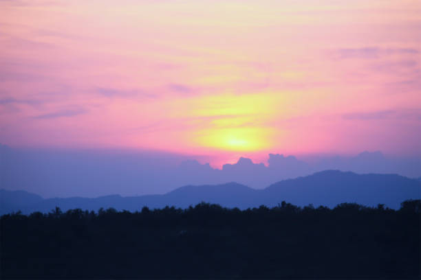 sky sunset yellow-pink behind mountains