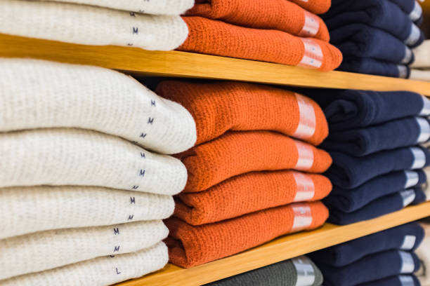 Variety of shirts hanging on rack in clothing store