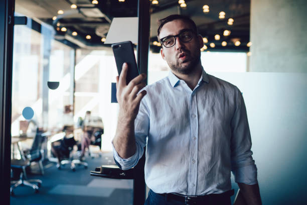 istock Amazed male broker in optical eyeglasses checking money exchange analytic on financial smartphone website connected to office internet, shocked wonder entrepreneur reading received mobile email 1432433908