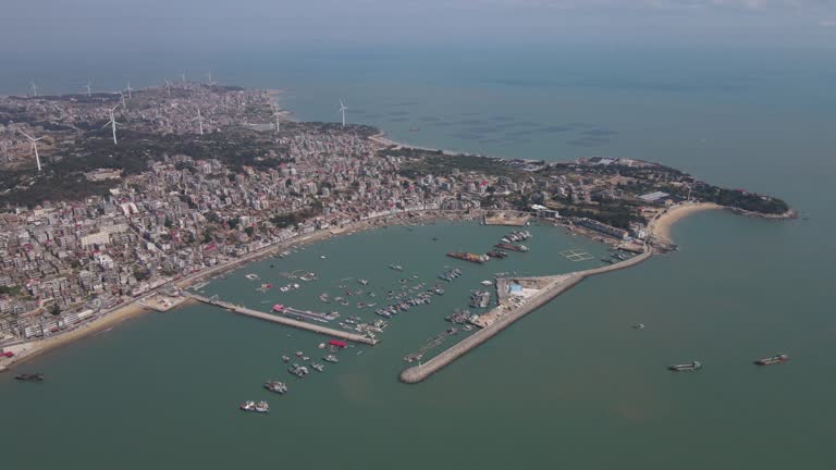 Aerial view video of the dyke of the fishing port and the docked ships