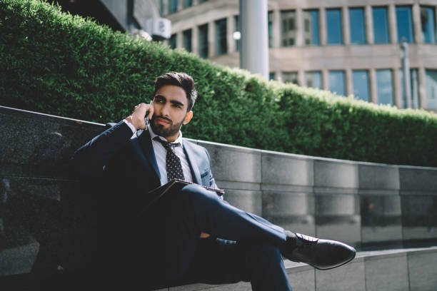 istock Smart young male speaking on cellphone 1432434121