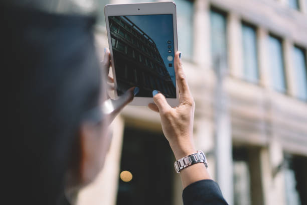istock Faceless woman taking photo on tablet 1432434141