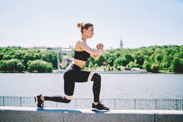 istock Sportive woman crouching bending leg and clasped hands 1432435023