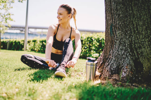 istock Excited jogger tying sport shoes preparing for run 1432435057