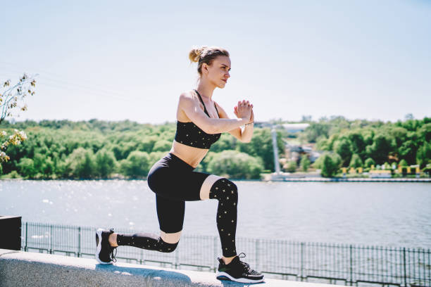 istock Powerful woman doing lunges and squatting with folded hands 1432435078