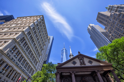 New York City Lower Manhattan Skyscrapers from below, Trinity Church and One World Trade Center in the picture.