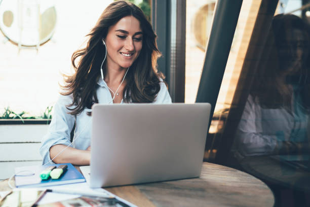 istock Happy lady using laptop in cafe 1432437917